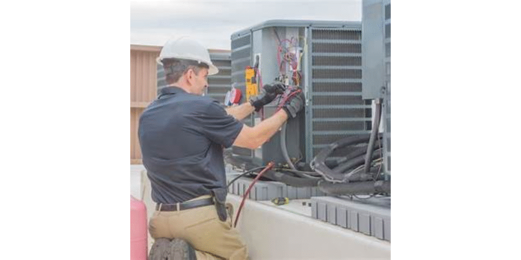 tech performing maintenance on hvac system